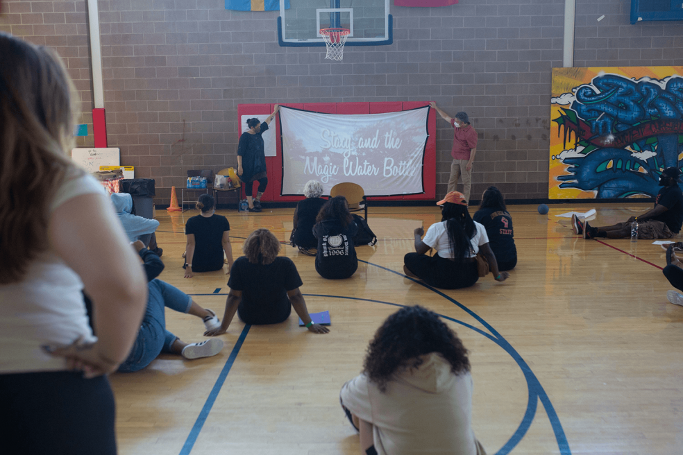 CYP staff watch Stacy and The Magic Water Bottle to kick off the event. Photo courtesy of Lesley University.