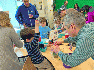 Families and K-5 students design terrariums out of recyclables for their airplants